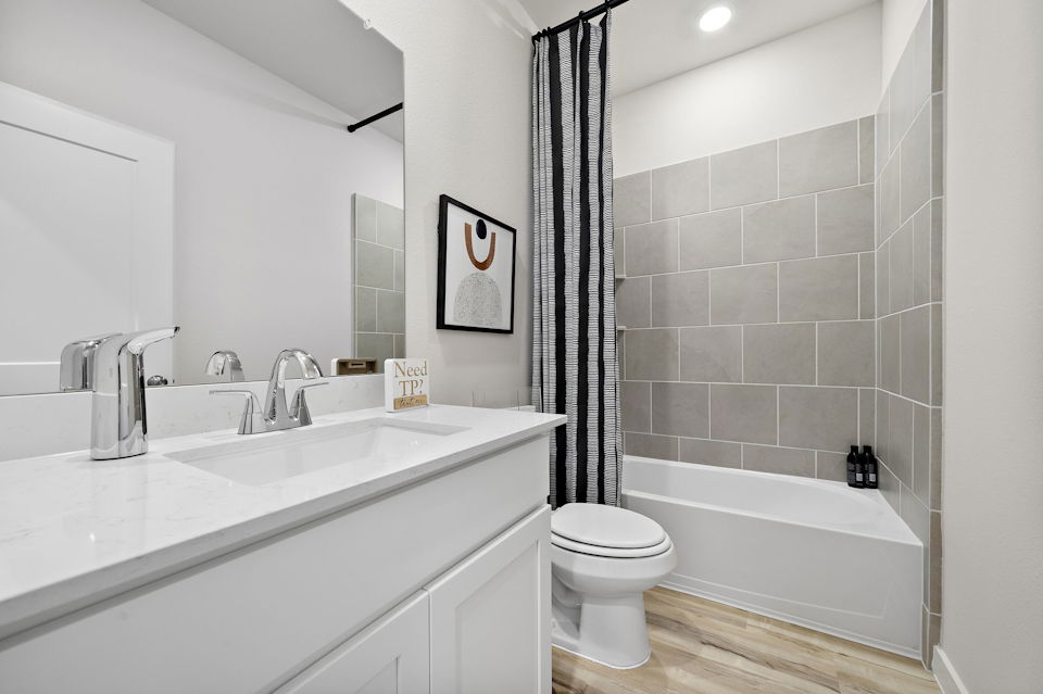 A bathroom with a tub sink and toilet.