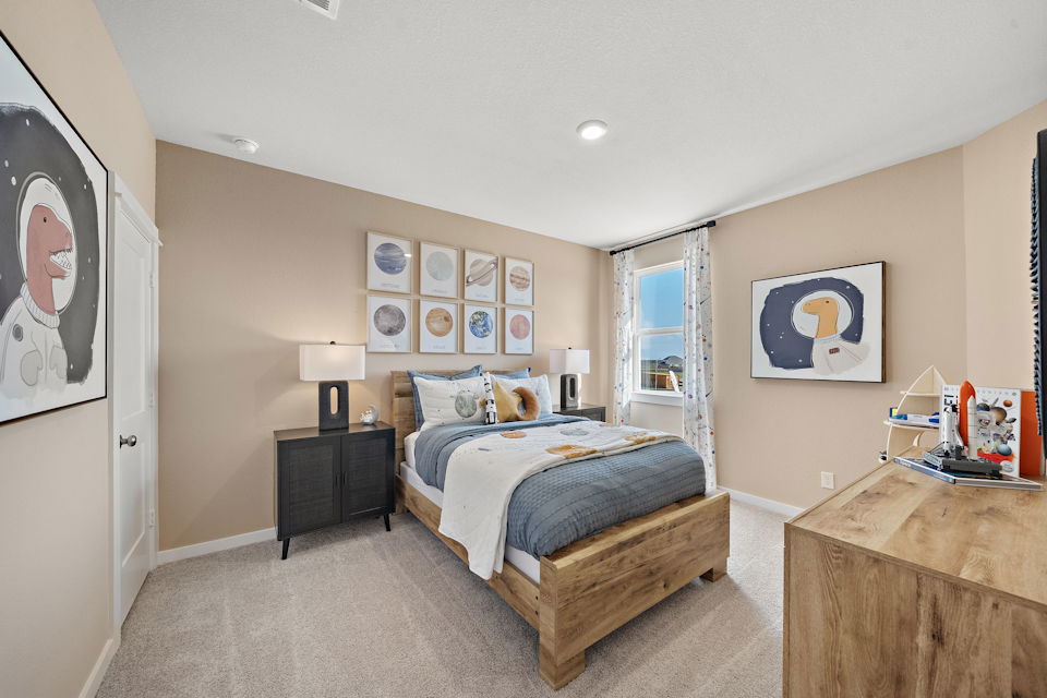 A bedroom with a bed and a bench.