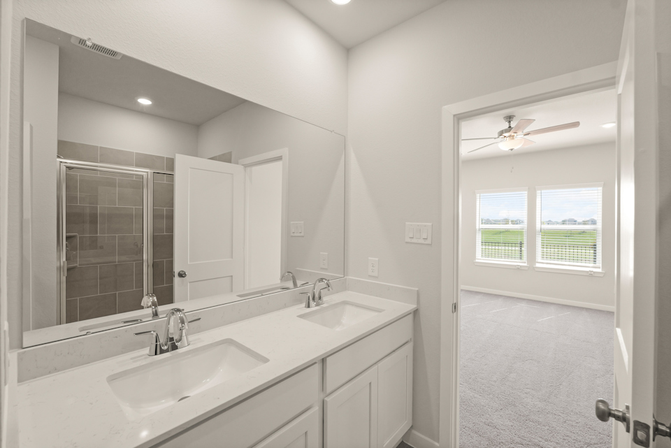 A bathroom with a large mirror.