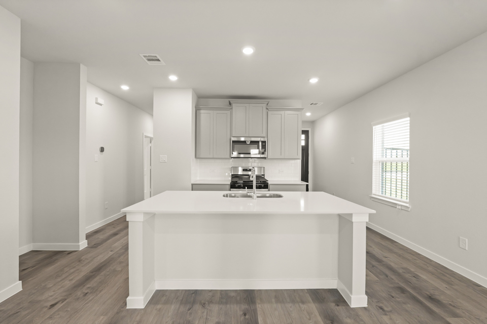 A kitchen with a white counter top.