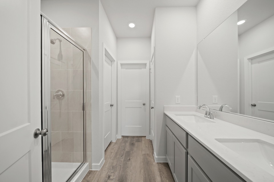 A bathroom with white cabinets.