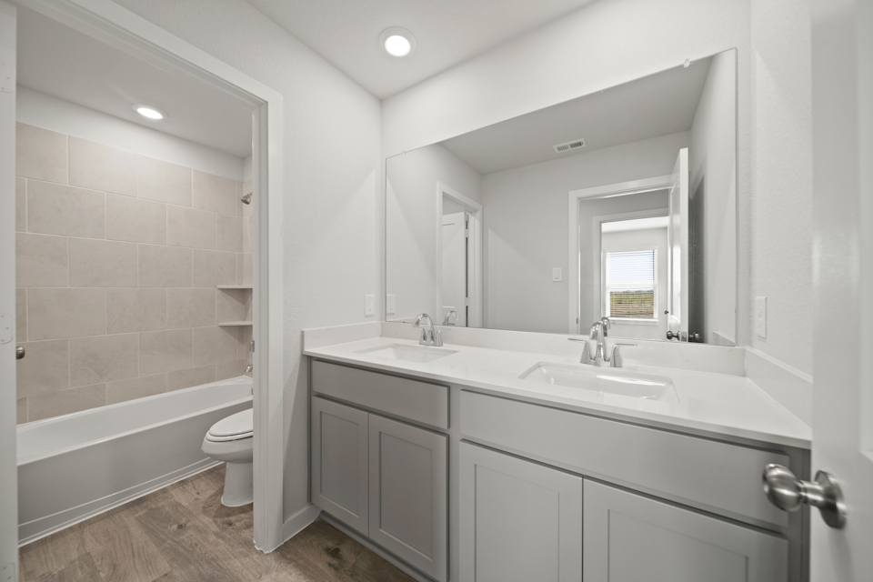 A bathroom with a tub sink and toilet.