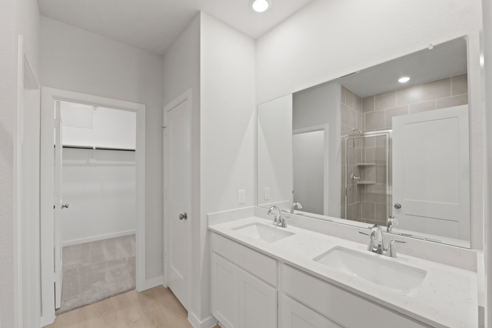 A bathroom with a large mirror.