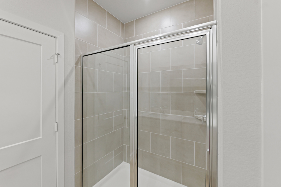 A shower with glass doors.