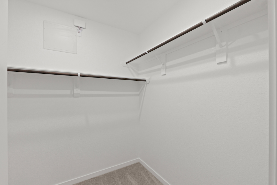 A white wall with a metal bar.