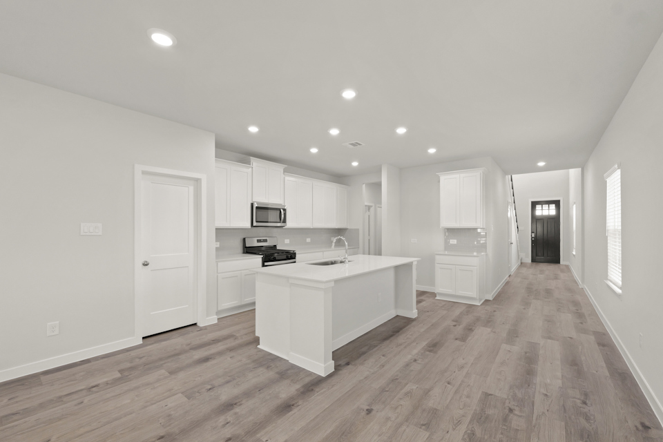 A kitchen with white cabinets.