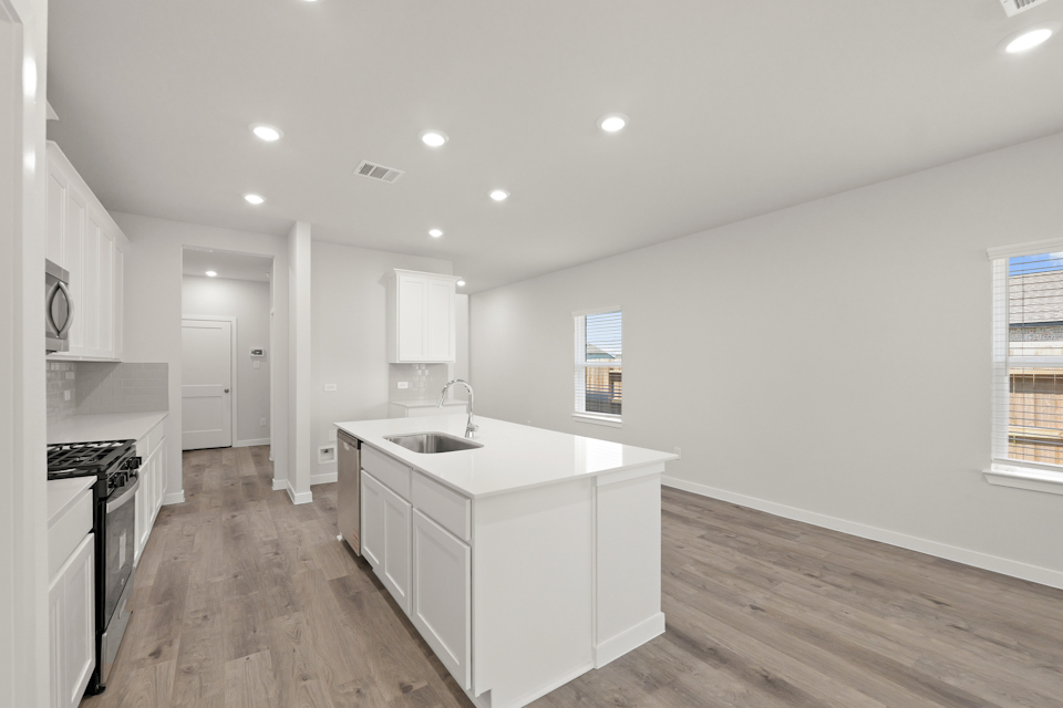 A kitchen with white cabinets.