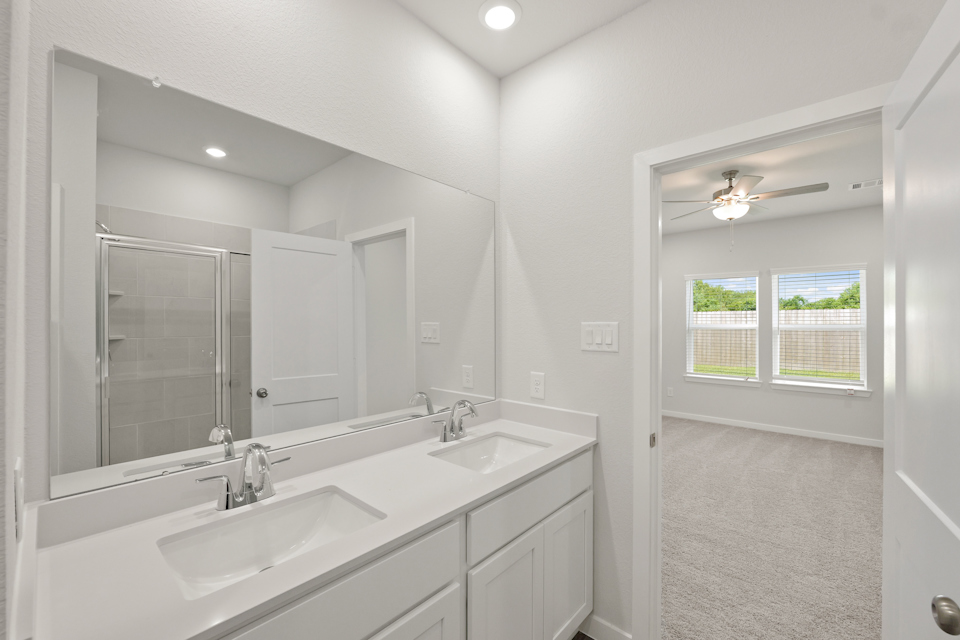 A bathroom with a large mirror.