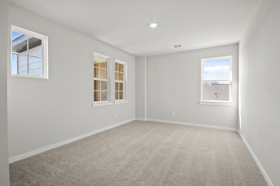 A room with a window and a rug.