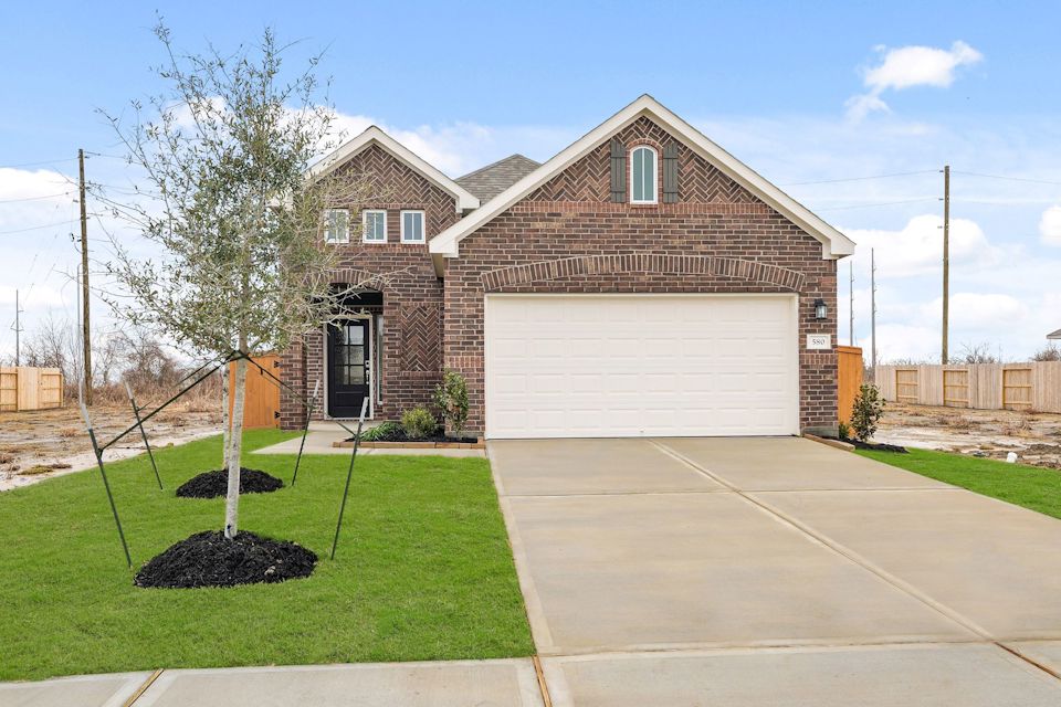 A large brick house with a garage.