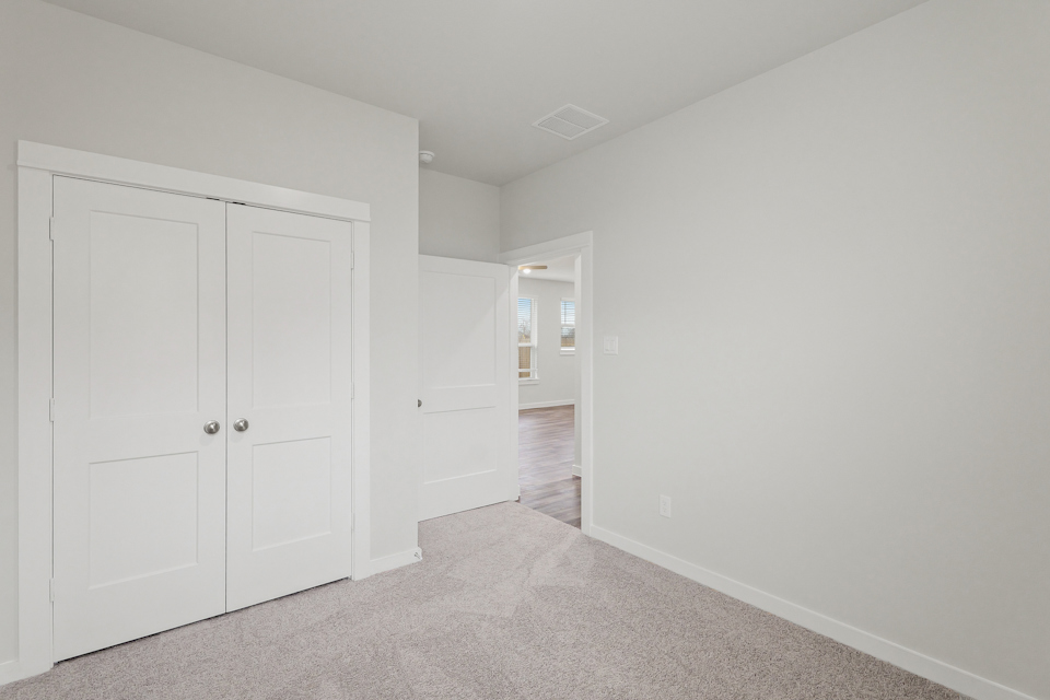 A hallway with white doors.
