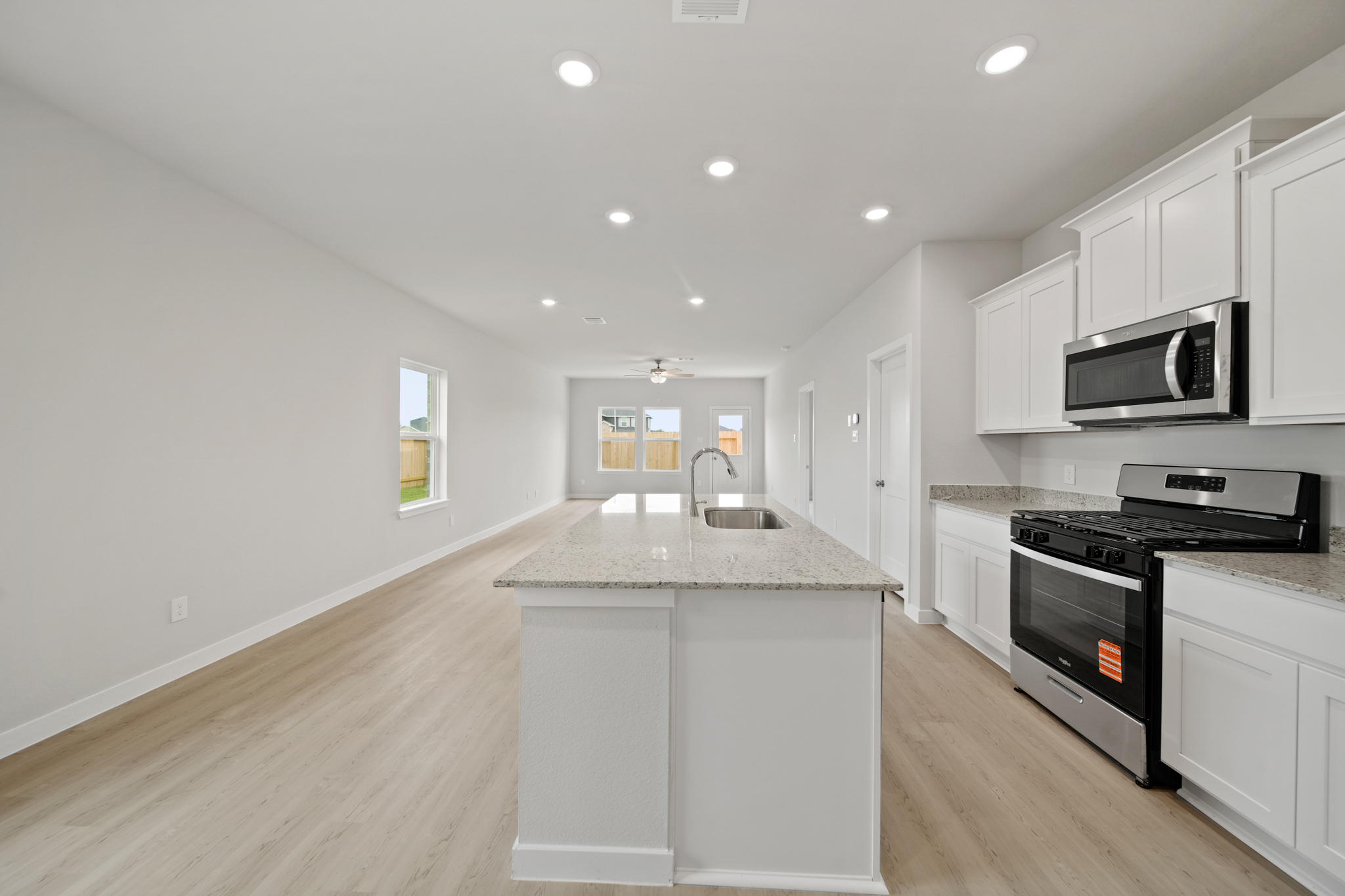 A kitchen with white cabinets.