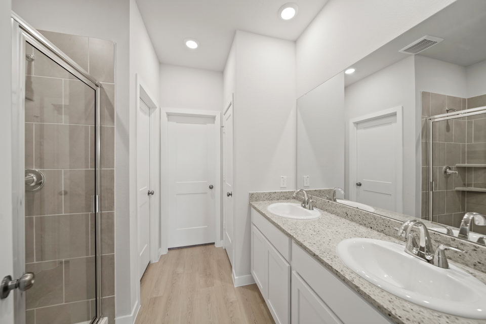 A bathroom with a large mirror.
