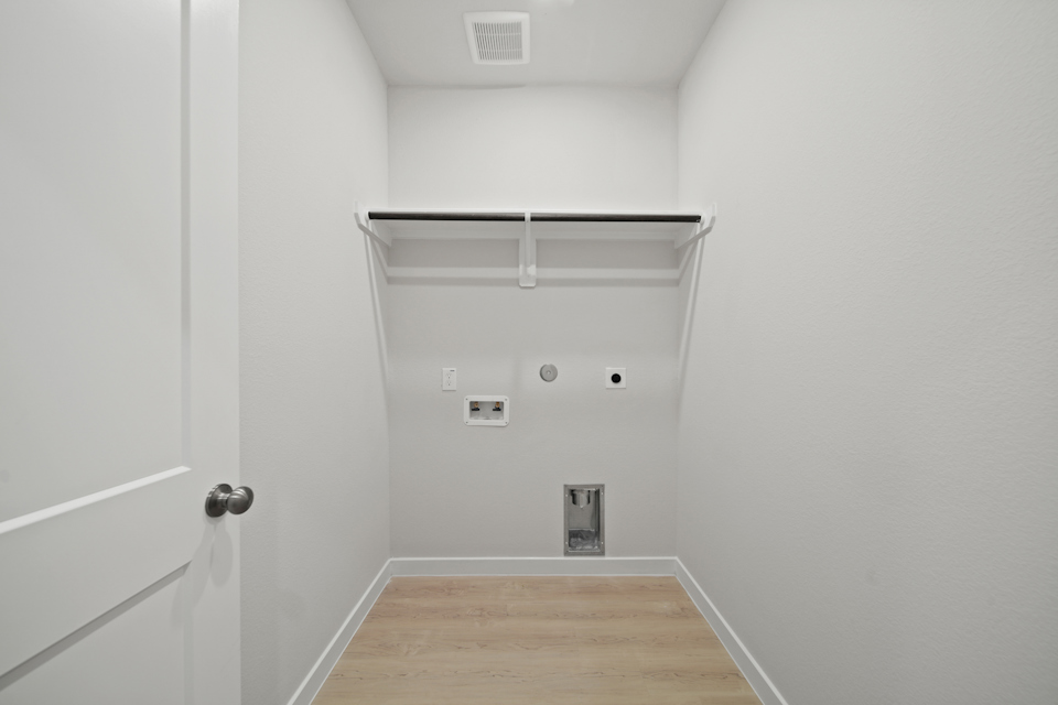 A white room with a wood floor.
