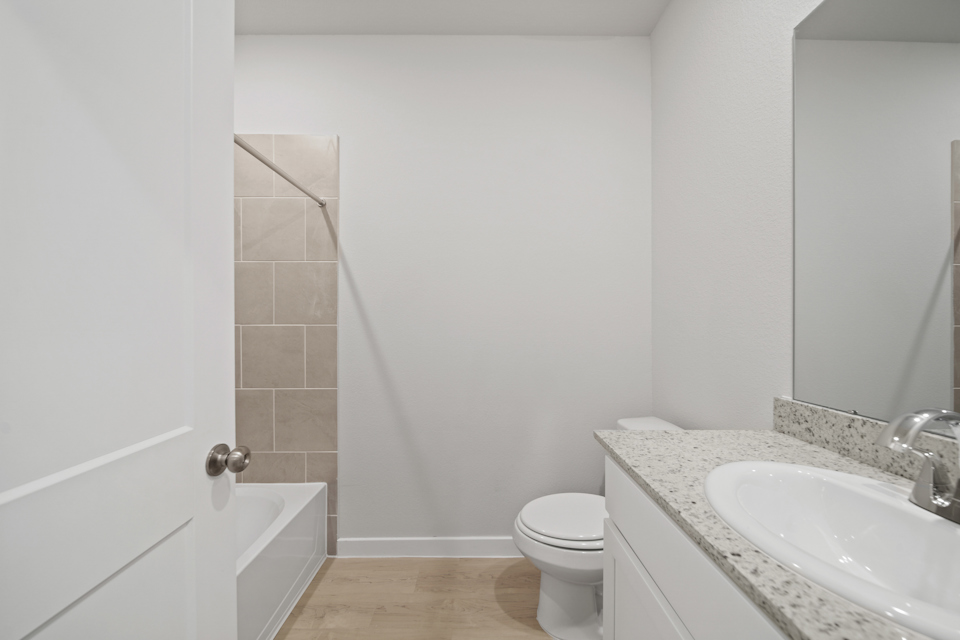A bathroom with a toilet sink and a bathtub.