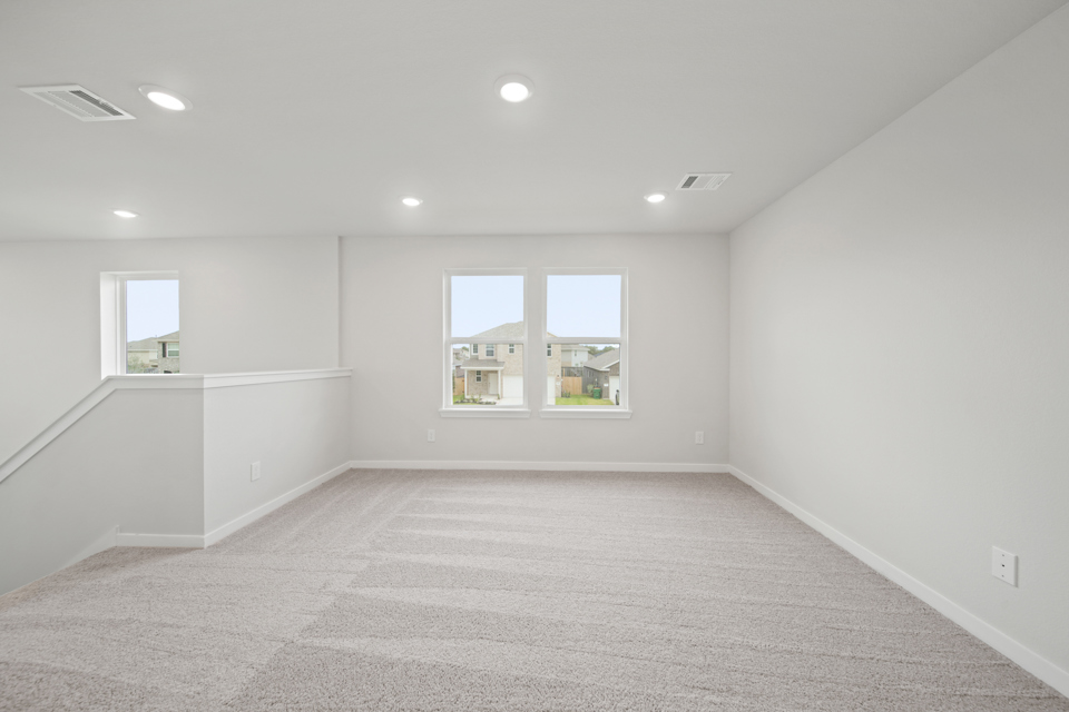 A room with a window and a carpet.