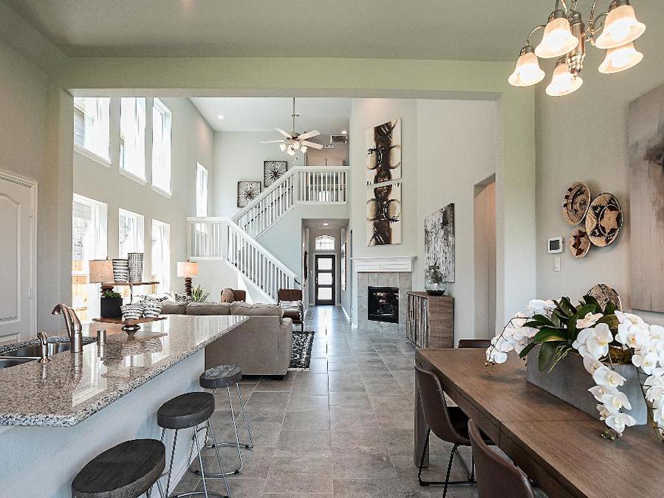 A kitchen with a fireplace and dining area.