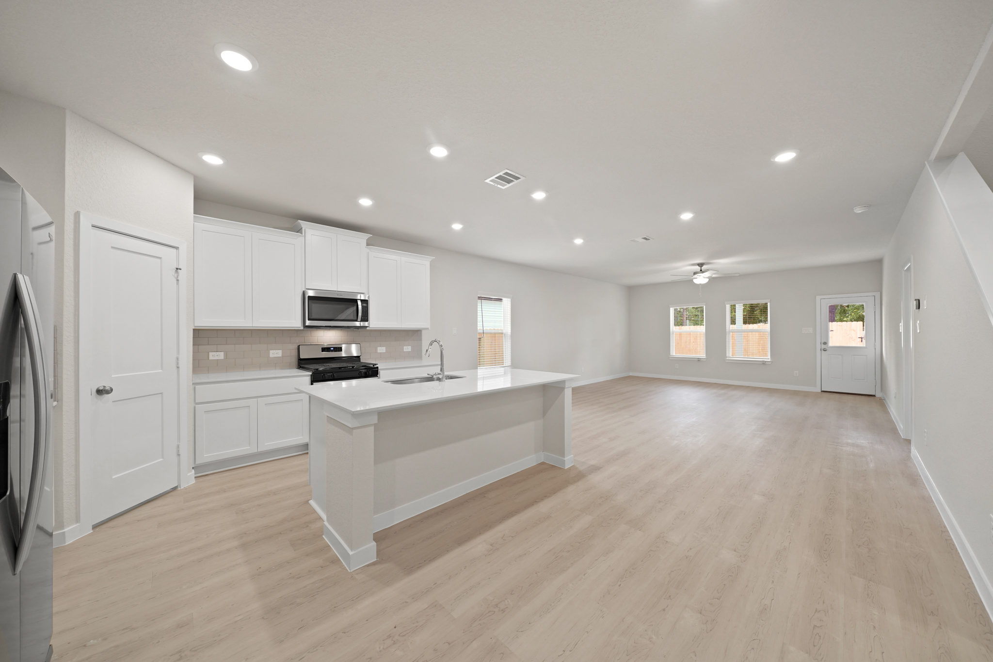 A large kitchen with white cabinets.