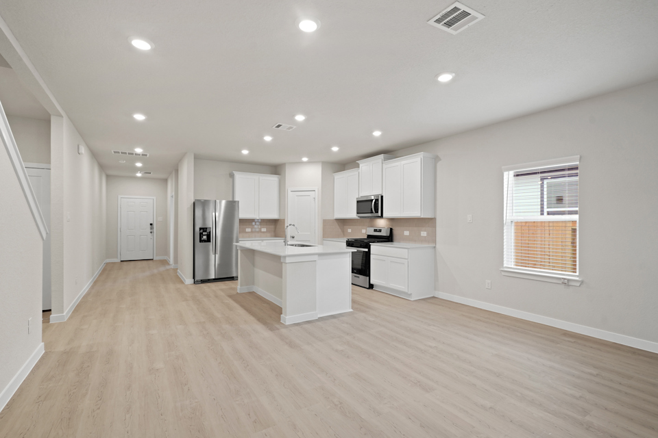 A kitchen with white cabinets.
