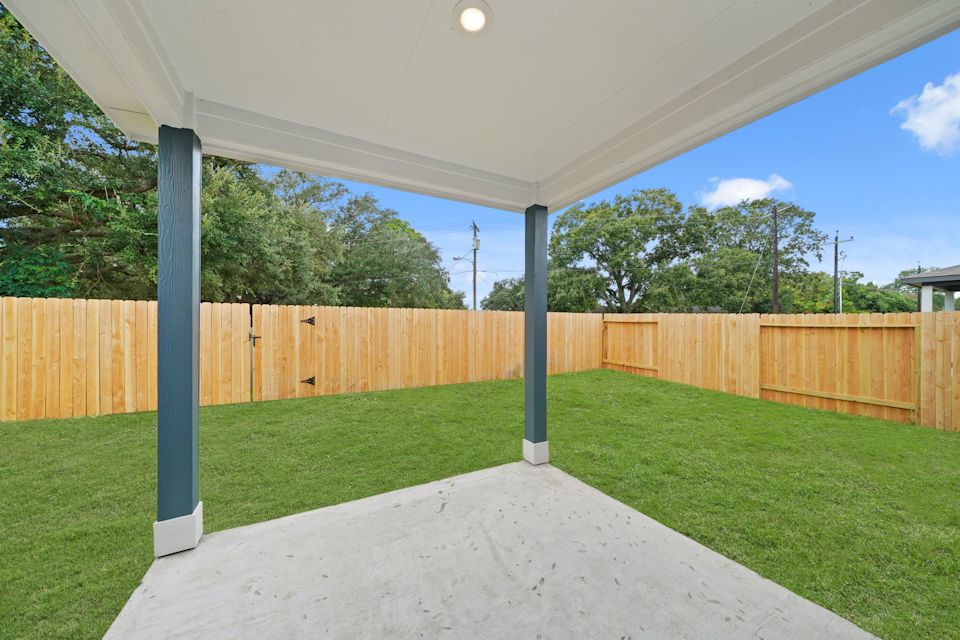 A backyard with a fence.
