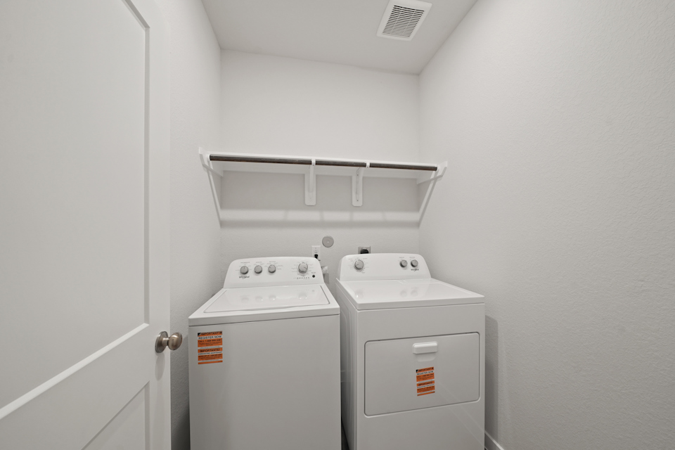 A washing machine in a room.