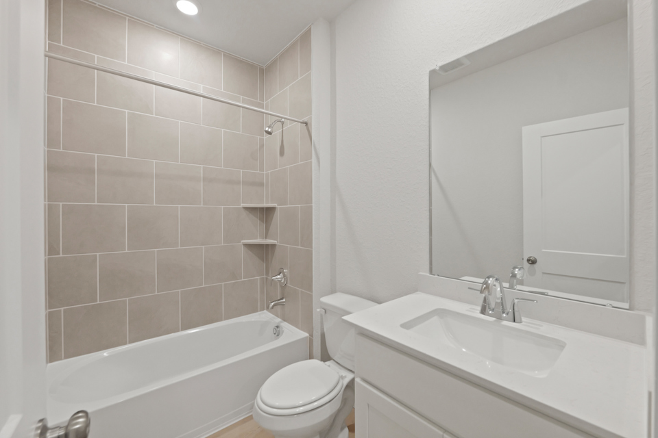A bathroom with a sink toilet and bathtub.