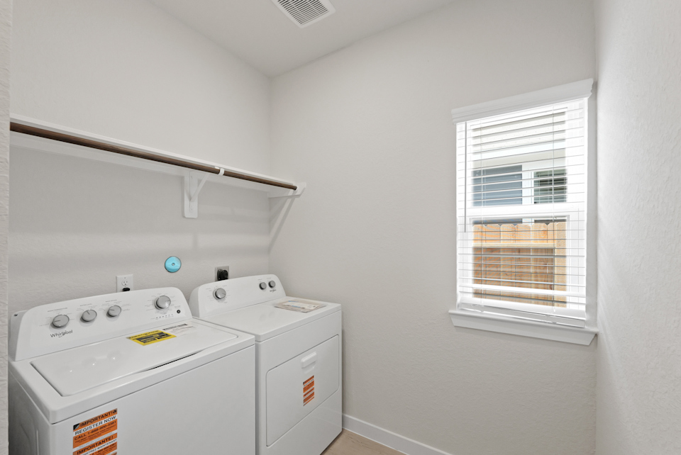 A laundry room with a washing machine.