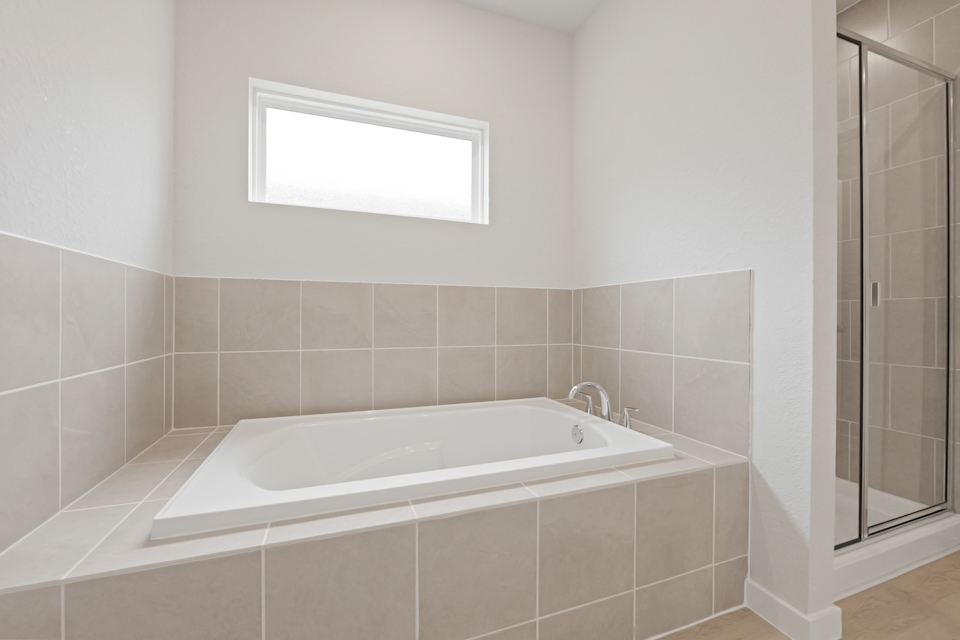 A bathtub in a bathroom.