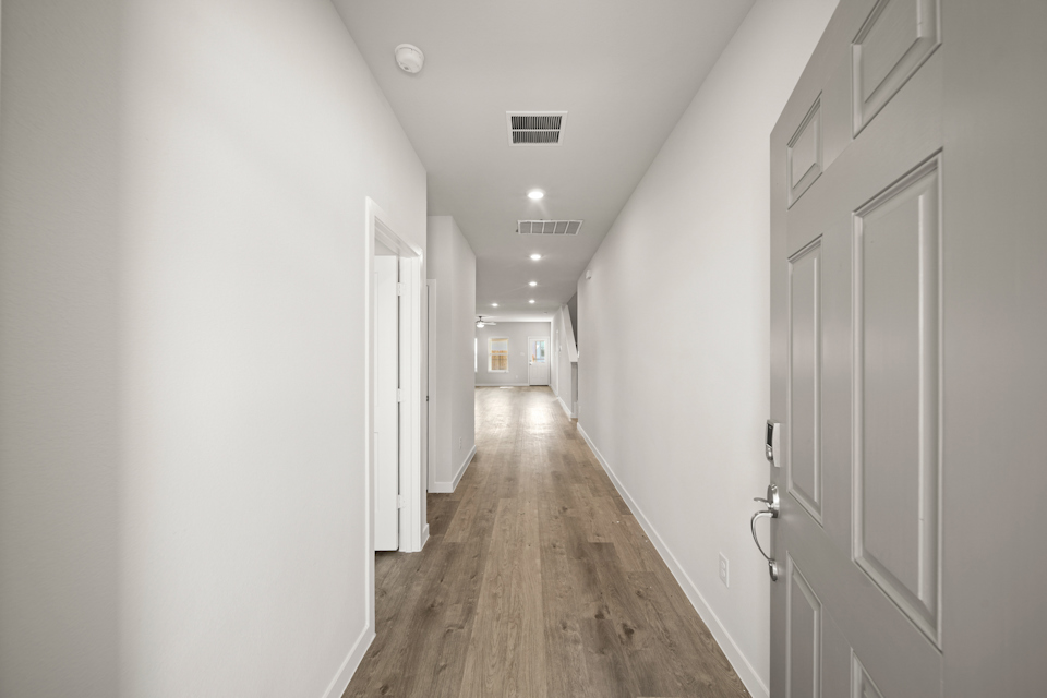A hallway with white doors.