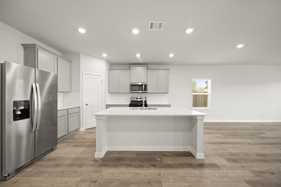 A kitchen with white cabinets.
