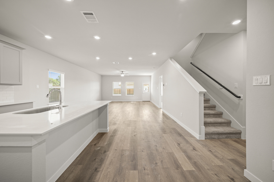 A large kitchen with white walls.