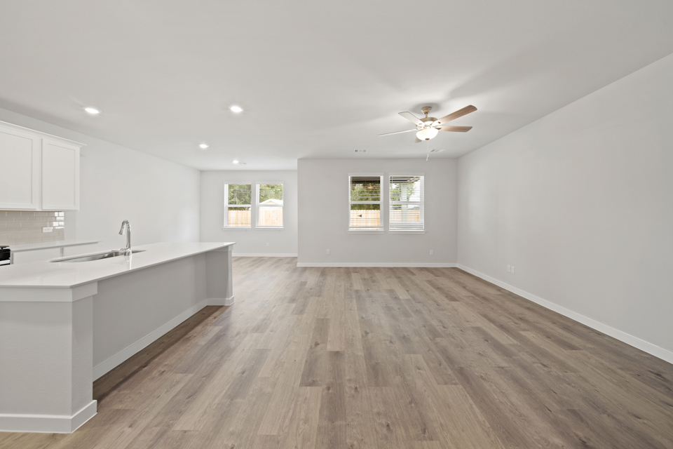 A kitchen with a wood floor.