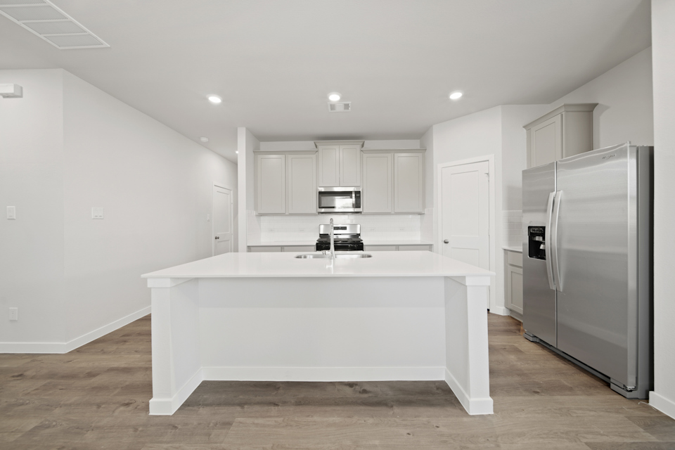A kitchen with white cabinets.