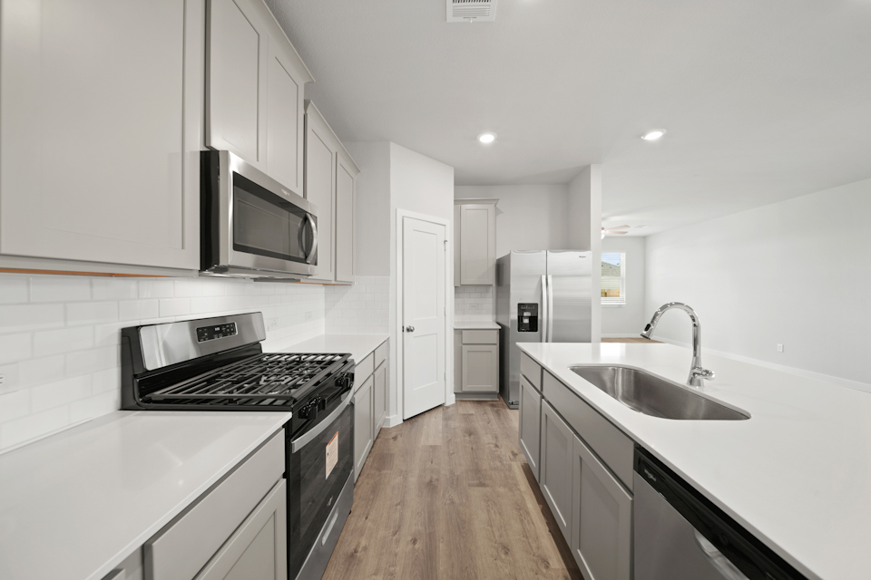 A kitchen with white cabinets.