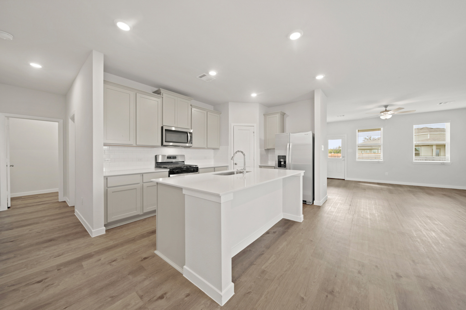 A kitchen with white cabinets.