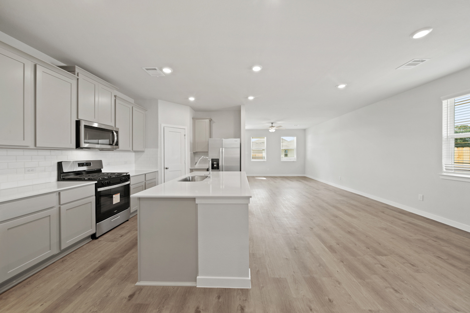A kitchen with white cabinets.