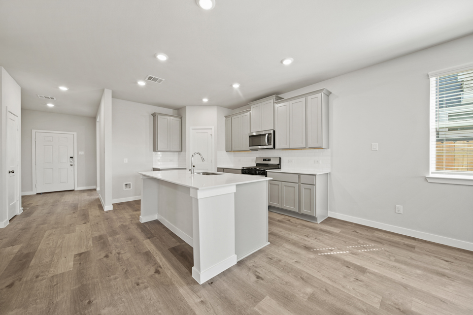 A kitchen with white cabinets.