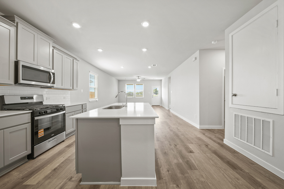 A kitchen with white cabinets.