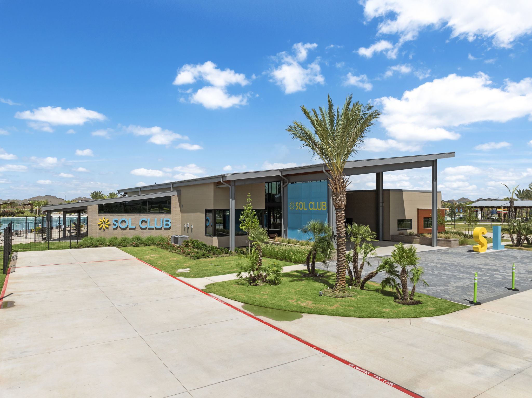 A building with a palm tree and a sign on the front.