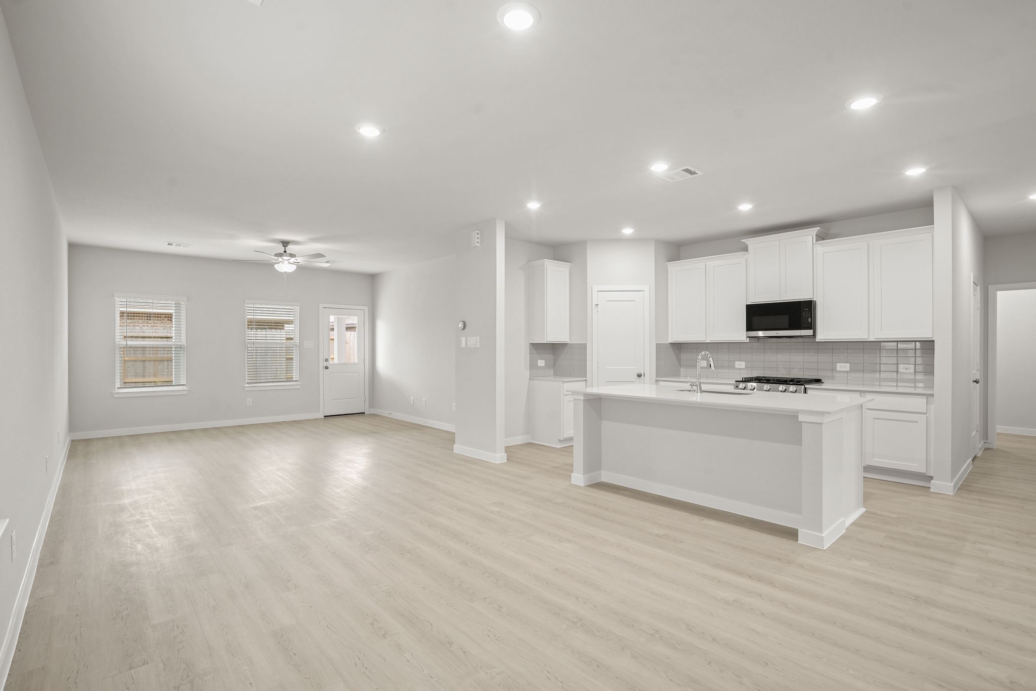 A large kitchen with white cabinets.
