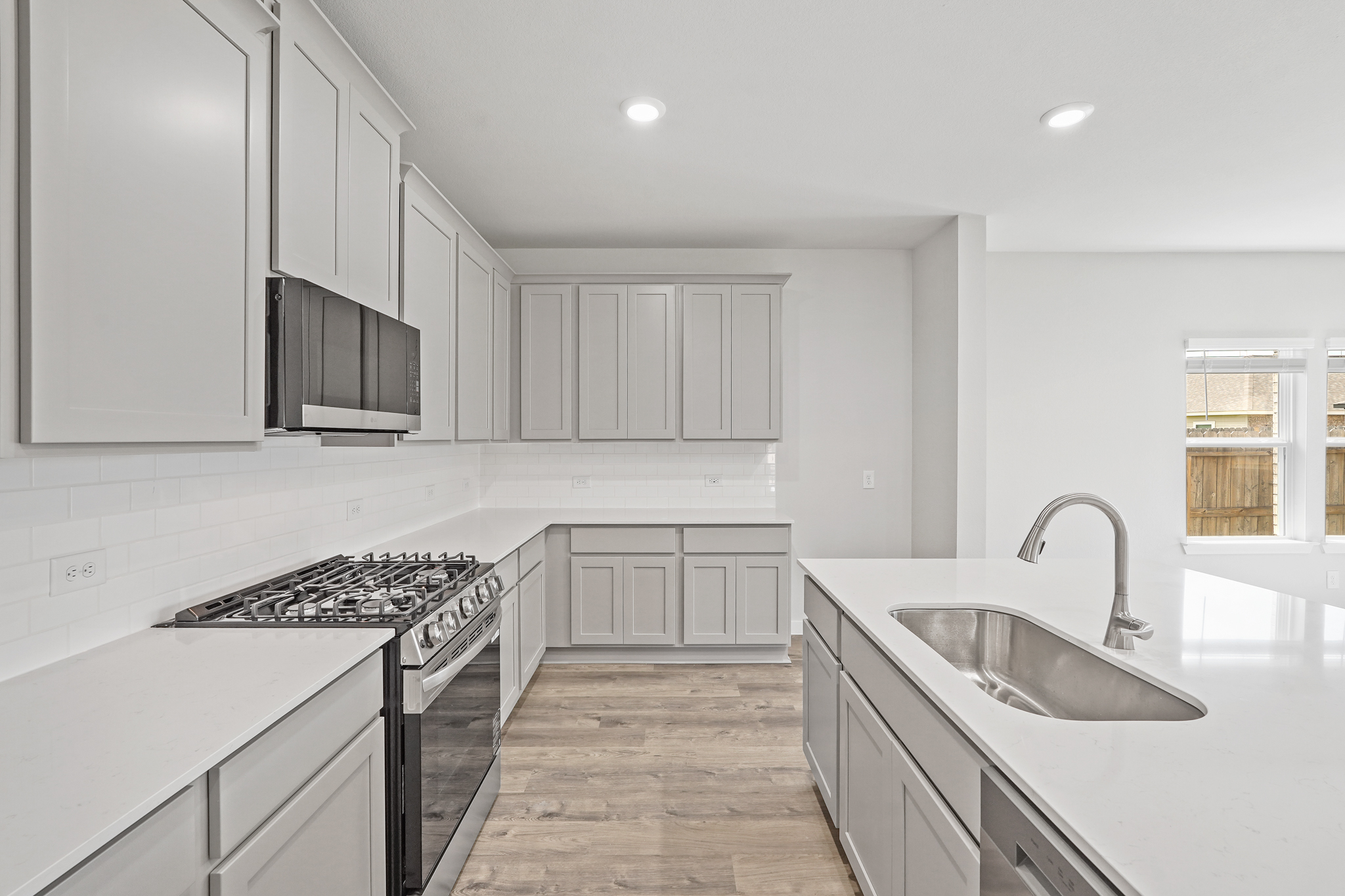 A kitchen with white cabinets.