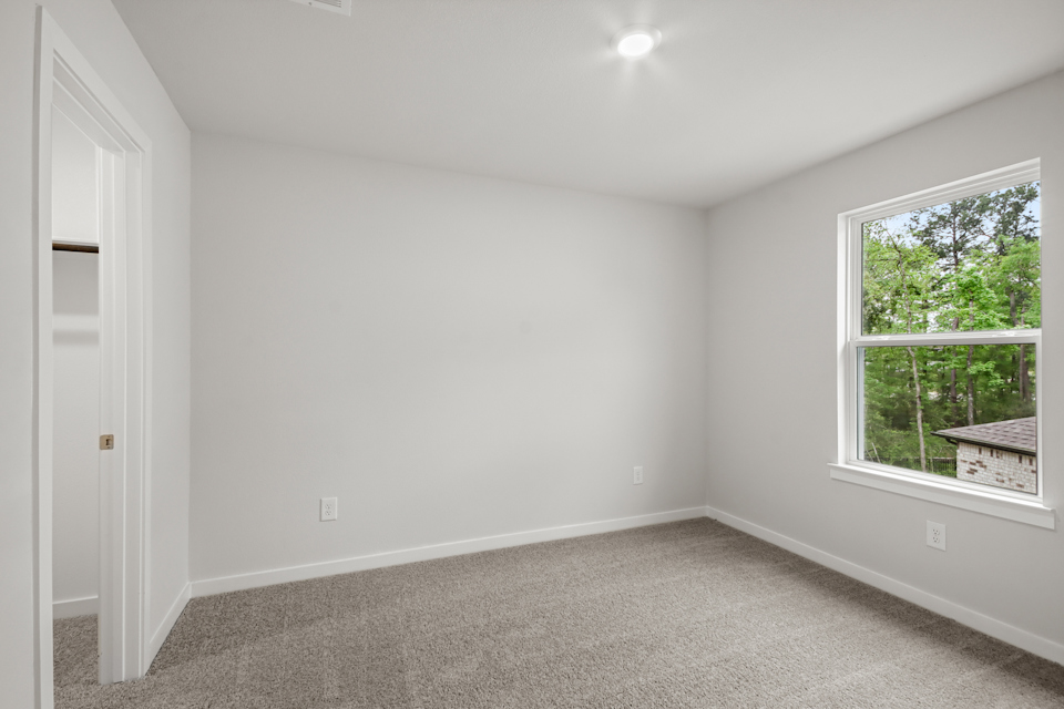 A room with a window and a door.