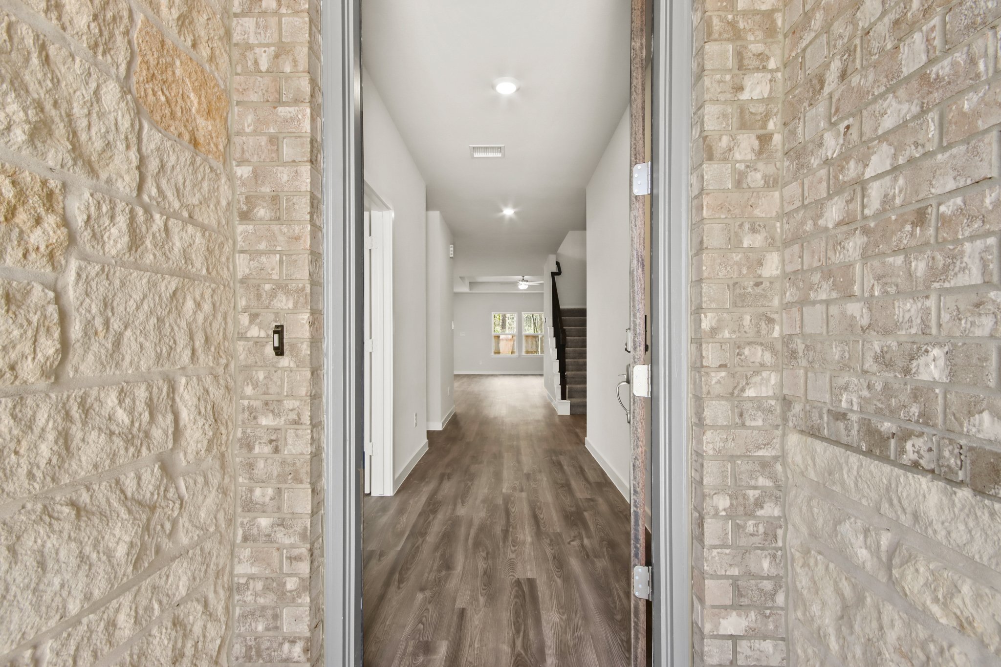 A long hallway with stone walls.