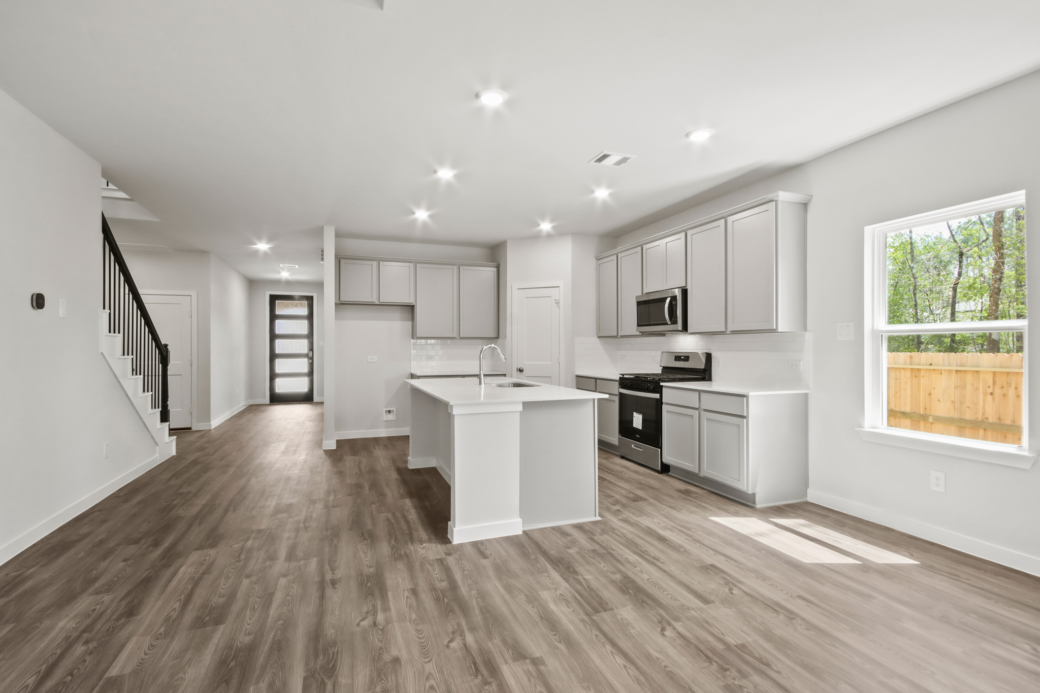 A kitchen with white cabinets.