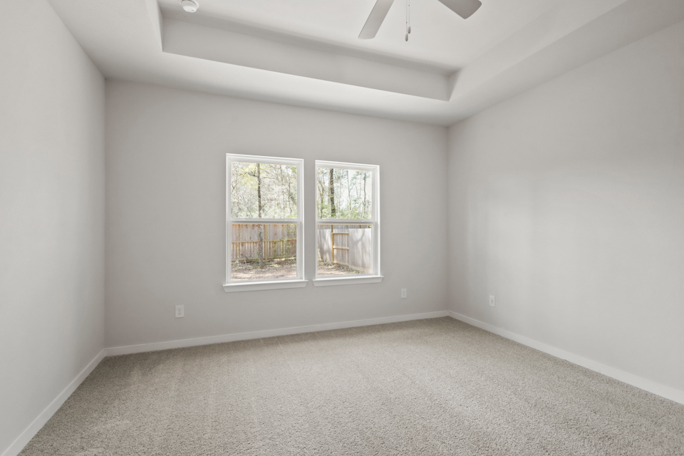 A room with a window and a carpet.