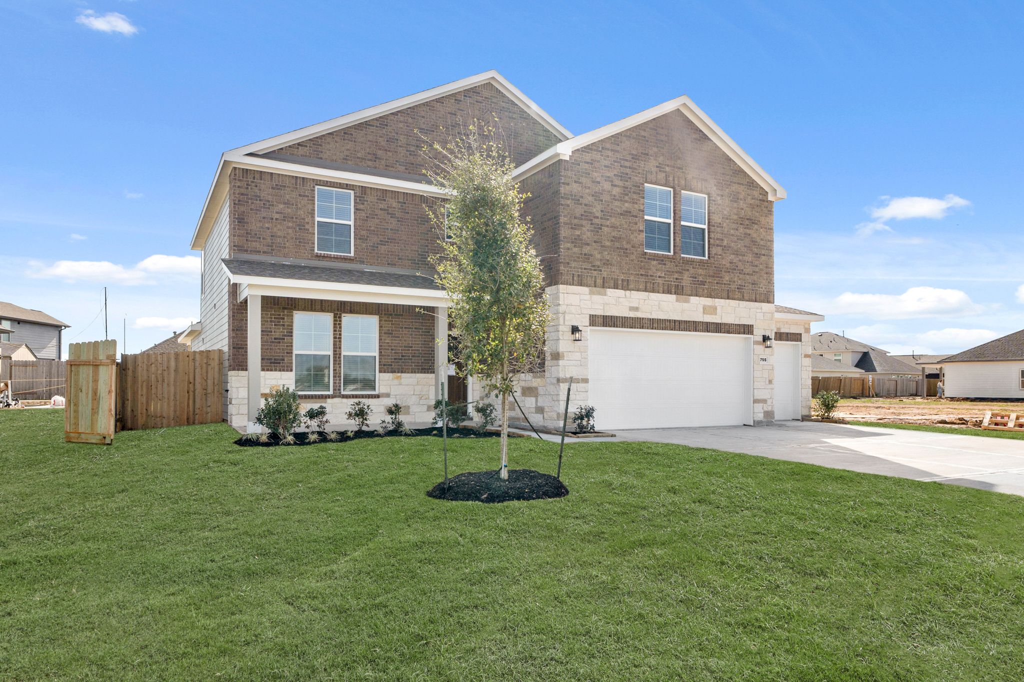 A house with a tree in the front yard.
