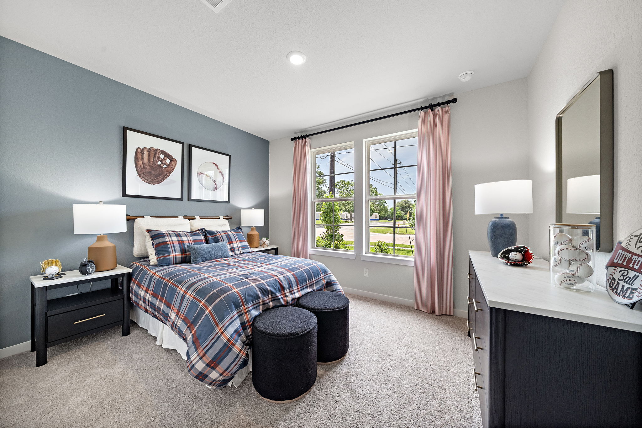 A bedroom with a bed and a mirror.