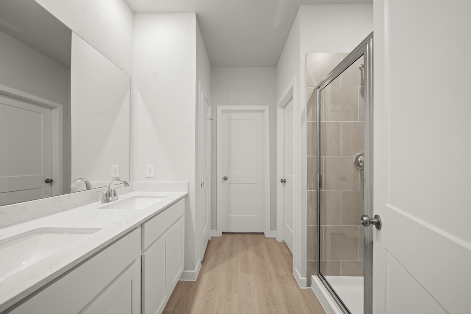 A bathroom with white cabinets.