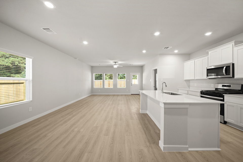 A kitchen with white cabinets.