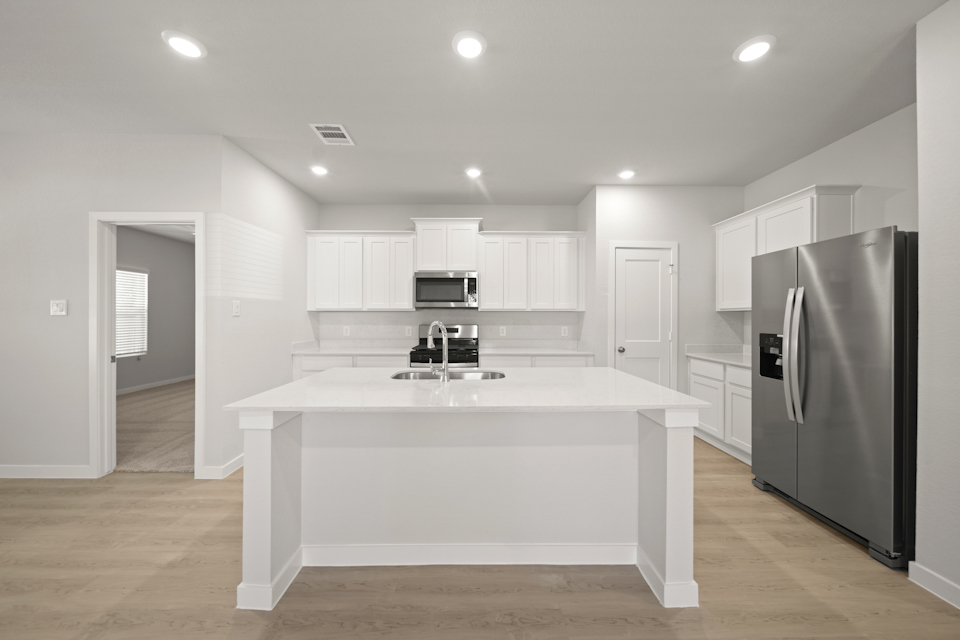 A kitchen with white cabinets.